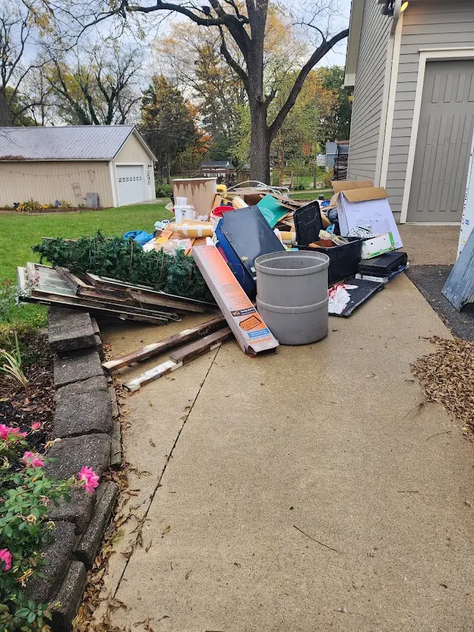Dumpster being loaded with debris for 10 Yard Dumpster Rental in Mill Creek